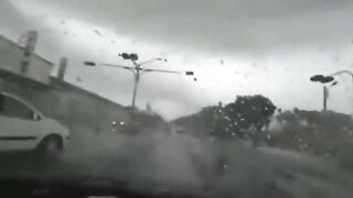 Tornado eats car in front.