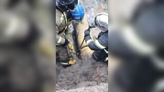 A man is stuck in a sewer pipe.
