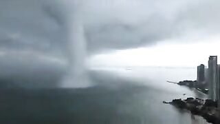 Waterspout reaching the shore