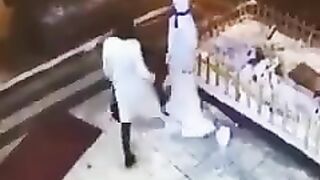 Crazy woman attacking a snowman gets what she deserves