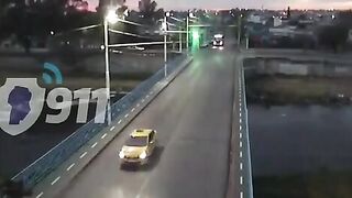 Idiot running a red light causes bus to fall off a bridge