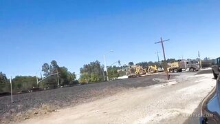 Train Demolishes Front Loader Stuck on Tracks