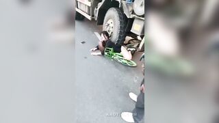 Men Gawk at Woman Suffering Under Truck