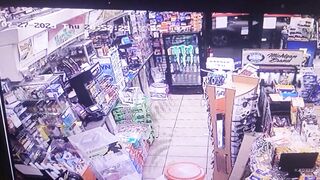 Customer guns down robber while holding a six-pack of Miller Lite beer