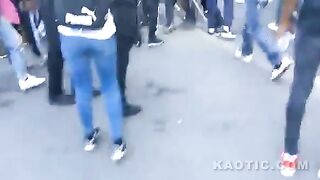 Group of people beating a guy