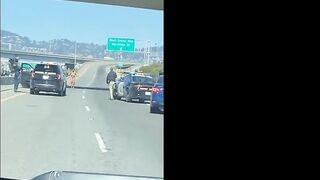 Another Angle Of of  Naked Woman Firing A Gun Shuts Down Highway In Oakland