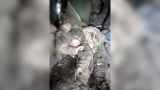 The corpse of the destroyed Ukrainian is pulled out of the dugout