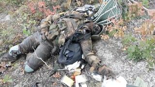 Russian soldiers inspect a black Ukrainian