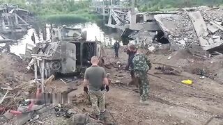 Drowned Ukrainian soldiers who fell from a destroyed bridge into the river, on an armored personnel carrier