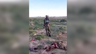 Somalia Soldiers Look at What's Left of their Comrade