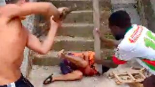 Thief is clubbed with wooden planks inside favelas - Brazil