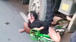 Oblivious cyclist ends up underneath a truck in China