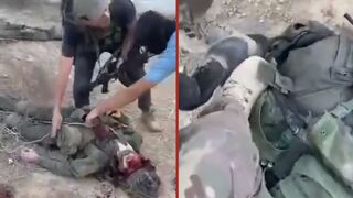 Dead Israeli soldiers are robbed of their equipment and stomped on by Palestinian fighters