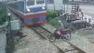 Man is wiped out by Train at crossing in Vietnam