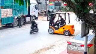 Scooter rider is clotheslined to the ground after colliding with a Forklift, Vietnam