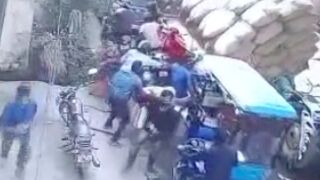 Unbalanced and unsecured heavy load crushes bikers waiting in traffic, India