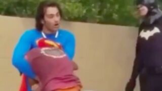 Homeless man is beaten by a man dressed in a superman uniform