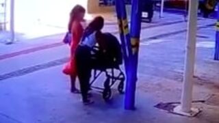 Man exits a car park from the second level on to a woman with a stroller