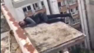 Rescue workers fail to save a drunk man who fell asleep on top of a balcony