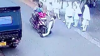 Youth walks out into the road and gets his leg snapped by a moped in Sri Lanka