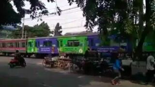 Moped rider gets swept by a Train in Indonesia