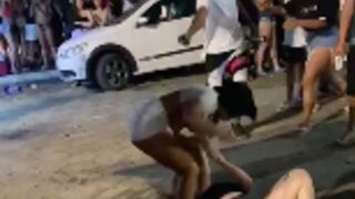 Two women fighting gets interrupted by gunman shooting one of them in the ass