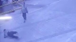 Man jumps out a building and lands right in front of passer by