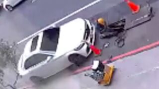 Woman driver fails to pay attention and crushes a worker in Taiwan