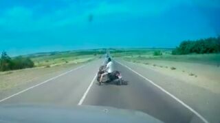 Old man attempts to turn around in the middle of a busy highway and gets dispatched in Russia