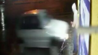 Car smashes into a man chilling against the wall