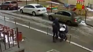 Man falls out a building and lands on a man pushing a stroller