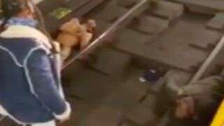 Two crackheads in agony on the subway tracks in new york