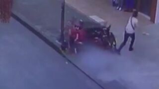 Man crashes his motorcycle into a lamppost and almost takes out a pedestrian on the sidewalk