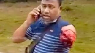 Man chilling on the phone to emergency services after getting his arm disconnected in a Motorcycle accident, Malaysia