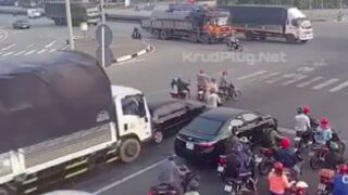 Scooter riders get swept buy a 18-wheeler that failed to stop at a junction