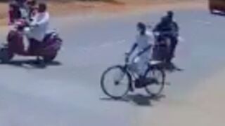 Motorcycle rider collides with a cyclist resulting in him and his passenger being crushed by a tractor