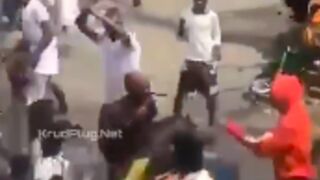 Police officer walks around with a knife stuck in his face after getting attacked by rioters in nigeria