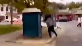 Guy tips over porta potty whilst somebody was inside it