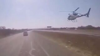 South African police immobilise and arrest suspect by blowing out his tyres from a Helicopter and police bike