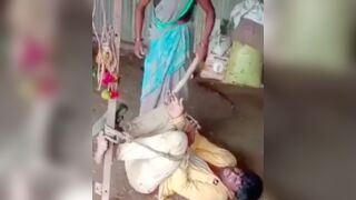 Man gets tied to a post and beaten with a stick by his wife for cheating in India