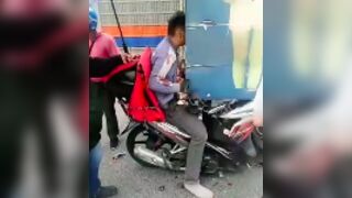 Scooter rider face plants into the back of a truck