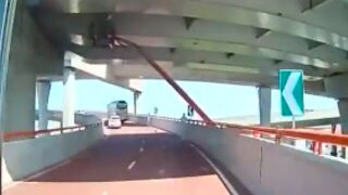 Maintenance worker gets hit from his crane while carrying out repairs underneath a bridge