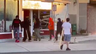 Rioters beat the hell out of female shop owner as husband pleads helplessly!