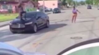 Woman gets hit by a car after getting into a fight while her kids watched!