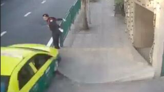 Traffic cop gets crushed against the railings by a Taxi!