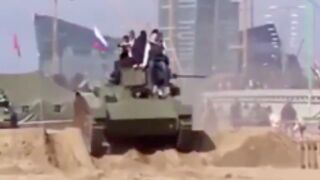 Men fall off the front of a tank and get crushed by it!
