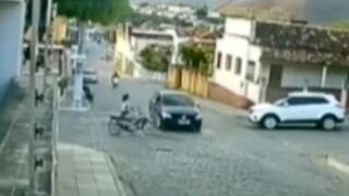 Woman crashes her motorcycle head on into the side of a car and does a 360 on the roof!