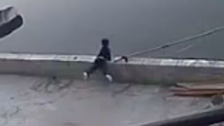 Young child falls over a wall into a river and almost drowns after throwing rocks!