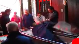 Dead man gets pulled out of his casket and beat up by his wife!