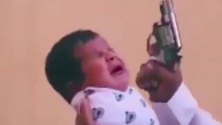 SMH: Stupid father fires a gun next to his babys ears and then puts it in his mouth to keep him quiet!